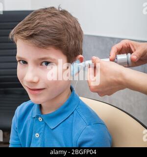 Process of making a custom earplug for a boy. Stages of manufacturing earplugs. doctor makes custom molded ear plugs for the patient Stock Photo