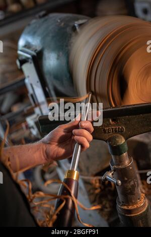 A wood turner working at a lathe. Stock Photo