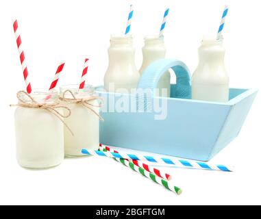 Milk in bottles with paper straws isolated on white Stock Photo
