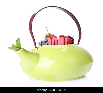 Forest berries and mint leaves in teapot, isolated on white Stock Photo