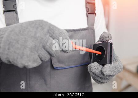 Electrician builder install working switches and sockets black color loft style Stock Photo