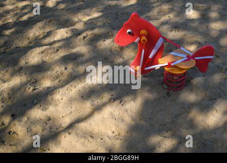 21 April 2020, Brandenburg, Frankfurt (Oder): A small rocking horse in a public playground is cordoned off with a tape because of the Corona crisis. Photo: Patrick Pleul/dpa-Zentralbild/ZB Stock Photo