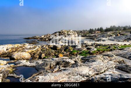 Rocky coast with small water puddles near Sjobadet Myklebust public swimming area, Tananger, Norway, May 2018 Stock Photo