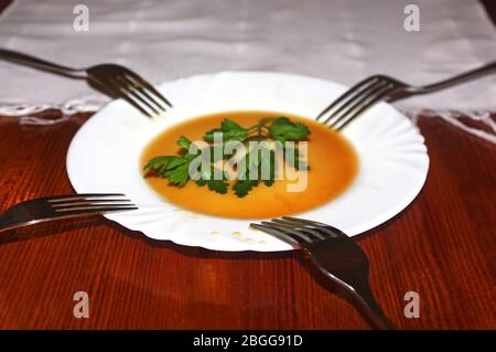 Empty white plate with pickle pickle and three forks on a wooden table. In the cafe. Pickles used for snacks when drinking vodka in Eastern Europe Stock Photo