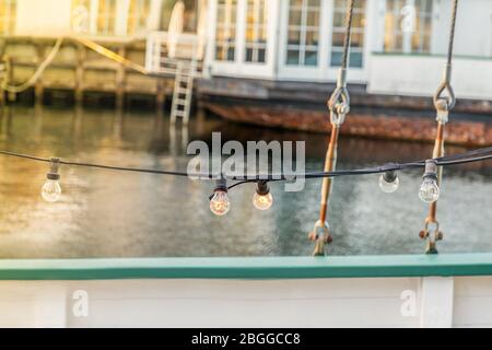 Details of old wooden boat and light bulbs line. Copenhagen, details Stock Photo