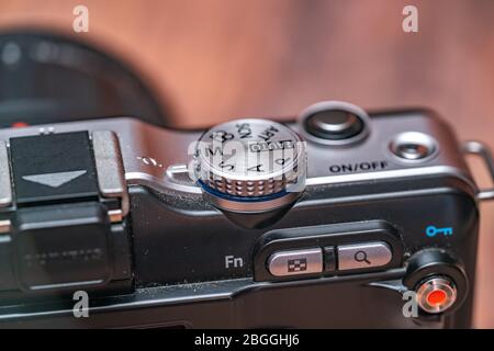 Norwich, Norfolk, UK – April 19 2020. Close up and selective focus on the mode dial on the back of a classic Olympus PEN mirrorless digital camera Stock Photo