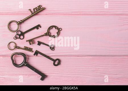 Vintage keys collection on a pink wooden background. Love and dream. Copy space Stock Photo