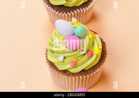 Bright pistachio Easter cupcake with decorations close up Stock Photo