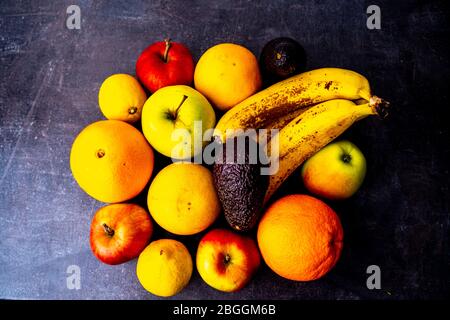 Top view of assorted fruits on black surface Stock Photo
