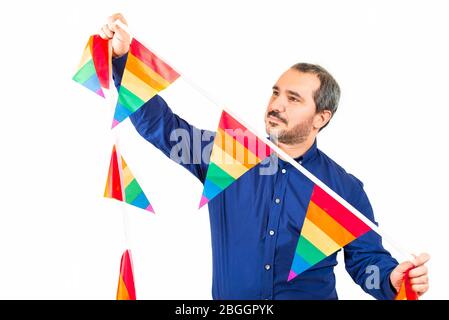 man placing garlands with the sign of gay pride Stock Photo