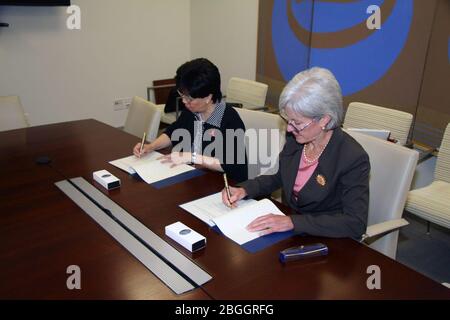 HHS Secretary Sebelius and WHO Director-General Margaret Chan join together to sign a Memorandum of Understanding between the U.S. Government and the World Health Organization. Stock Photo