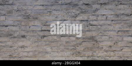 Brick wall texture, background in white oldstyle color. Uneven brickwork and wall, painted with white water-based paint. An old rough whitewashed wall Stock Photo