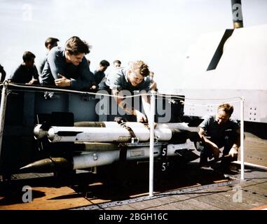 High-Velocity Aircraft Rockets (HVAR) are loaded and prepared on a US ...
