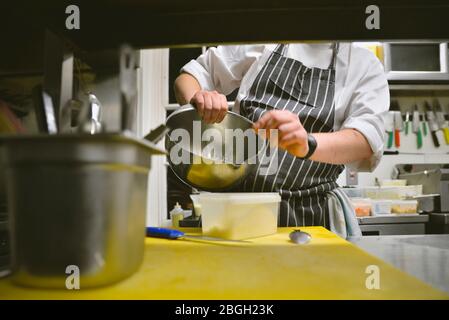 https://l450v.alamy.com/450v/2bgh23k/chef-putting-grated-cheese-in-plastic-container-2bgh23k.jpg