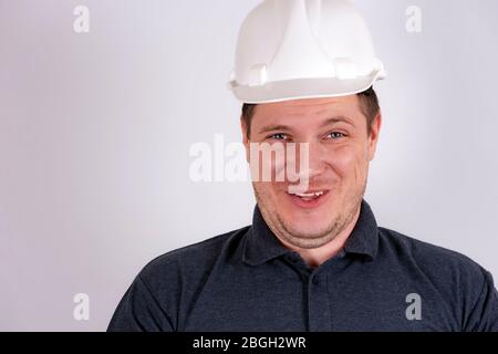 white male engineer in a white hard hat Stock Photo