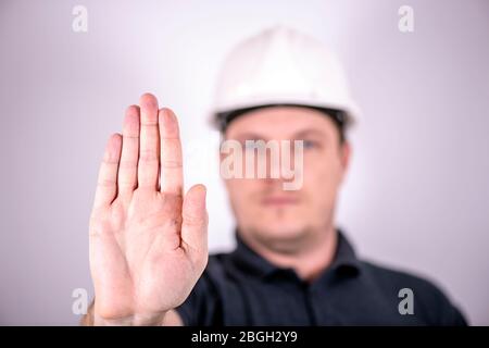 white male engineer in a white hard hat Stock Photo