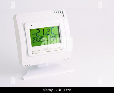 Remote home interior thermostat controller over white background. Stock Photo