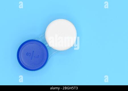 Contact lens case on blue pastel background . Stock Photo