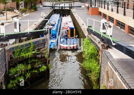 Two narrowboats travelling through Meadow Lane Lock on the Nottingham Beeston Canal, Nottingham, England, UK Stock Photo