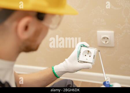 Electrician builder install working switches and sockets black color loft style Stock Photo