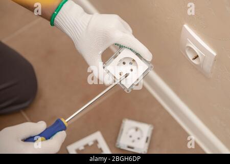 Electrician builder install working switches and sockets black color loft style Stock Photo