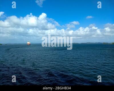 A cargo ship on Gatun Lake, going between the locks on the Panama Canal. Stock Photo