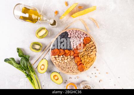 Food sources of vitamin E, high in antioxidants, anthocyanins, minerals and fiber, The concept of healthy food for brain and heart on concrete backgro Stock Photo