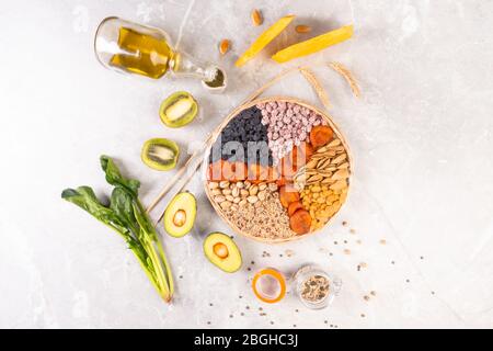 Food sources of vitamin E, high in antioxidants, anthocyanins, minerals and fiber, The concept of healthy food for brain and heart on concrete backgro Stock Photo