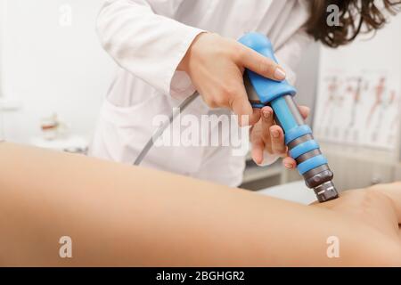 Extracorporeal Shockwave Therapy ESWT. Effective non-surgical treatment.Physical therapy of hamsting with shock waves. Pain relief, normalization and Stock Photo