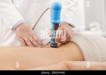Electrical stimulation massage for lower back pain Stock Photo - Alamy
