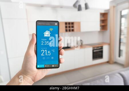 Smart home system on phone app. Temperature, energy efficiency, security control. Stock Photo