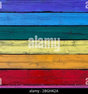 square bright textured background from old wooden planks painted in different colors of the rainbow Stock Photo