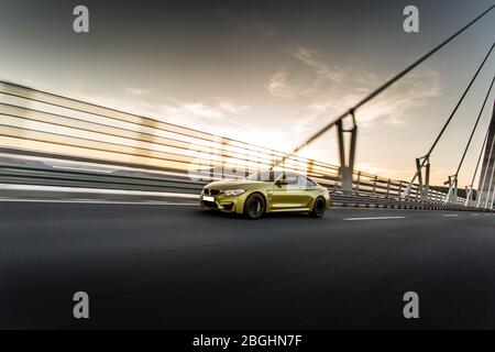 Yellow sport model sedan high speed drive over the bridge,futuristic view Stock Photo