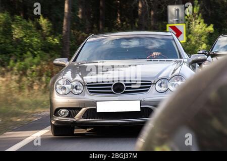 Chasing cars landscape drive in the sunset in the forest,front view Stock Photo