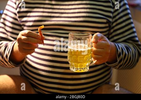 A man drinks beer and eats crayfish Stock Photo