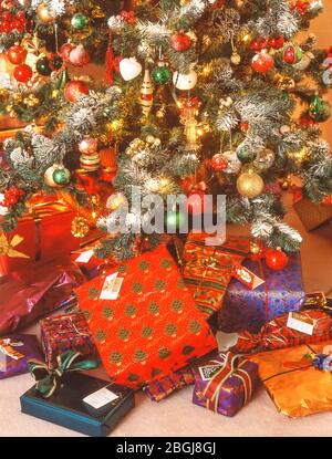Christmas presents underneath Christmas tree, Ascot, Berkshire, United Kingdom Stock Photo