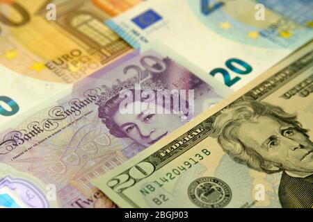 Pounds, dollars and euros placed on top of each other. Financial concept photo for currency exchange, banking, internationsl trading, global economy. Stock Photo