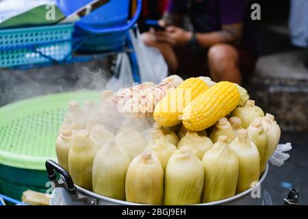 Corn cobs in pan at street market Stock Photo