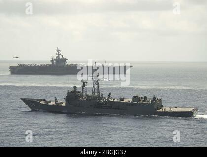 HMAS Newcastle steams alongside aircraft carrier USS Dwight D. Eisenhower in June 2013. Stock Photo