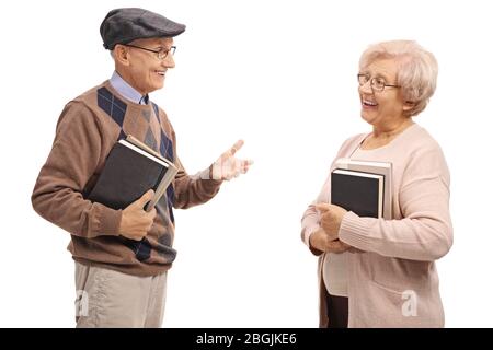 Elderly man holding books and talking to an elderly woman isolated on white background Stock Photo