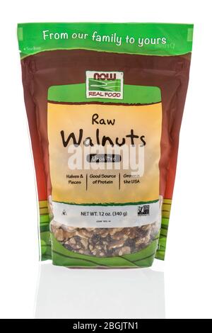 Winneconne,  WI - 21 April 2020:  A package of Now real food raw walnuts on an isolated background. Stock Photo