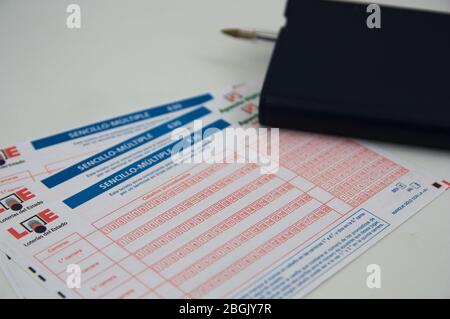 September 2019. Spain. Tickets of one of the lotteries of the Spanish State, next to a notebook and a pen on a white table Stock Photo