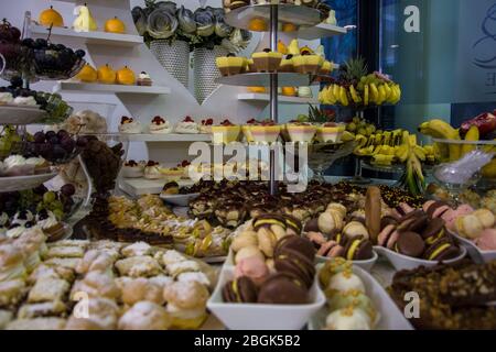Candy bar at the wedding with different sorts of fruits and cookies in different colors and forms Stock Photo