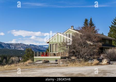 FAIRMONT HOT SPRINGS, CANADA - MARCH 21, 2020: wooden house in small town situated in rocky mountains. Stock Photo