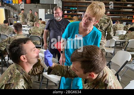 Medics with the Louisiana Army and Air National Guard conduct training with the Department of Health and Human Services to ensure proper protection and administering of drive thru testing, March 18, 2020 in New Orleans. (U.S. Army National Guard photo by Maj. John Meche) Stock Photo