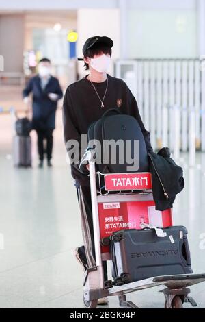 Chinese singer Shi Zhan arrives at a Beijing airport before departure ...