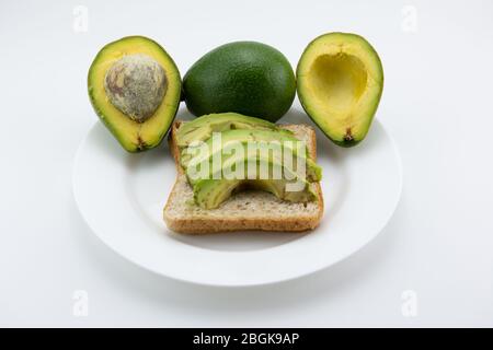 Bread with sliced avocado for a healthy breakfast. Stock Photo