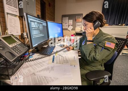 Tech. Sgt. Alex Morhead, 167th Aeromed Evacuation Squadron, 167th Airlift Wing, West Virginia National Guard (WVNG), assists state partner agencies by manning phone lines at the West Virginia Poison Center, part of the statewide Coronavirus 2019/COVID-19 response efforts, March 19, 2020, in Charleston, West Virginia. The members are answering questions and inquiries from concerned citizens on a hotline established as part of an interagency whole-of-government approach in response to the ongoing pandemic. (U.S. Army National Guard video by Edwin L. Wriston) Stock Photo