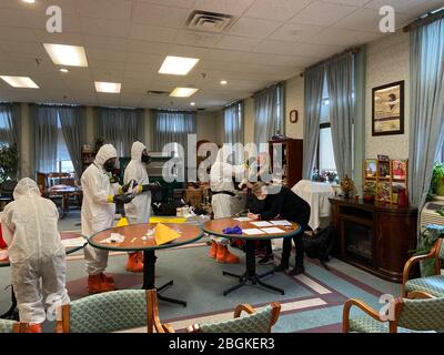 Members of the West Virginia National Guard's Chemical, Biological, Radiological, Nuclear and High Yield Explosive (CBRNE) Battalion and 35th Civil Support Team (CST) provide assistance for COVID-19 swabbing for the staff of a nursing facility March 23, 2020, in Morgantown, West Virginia. West Virginia CBRN experts have been providing assistance to the State of West Virginia in response to the current COVID-19 outbreak. (U.S. Army National Guard photo by Sgt. Davis Rohrer) Stock Photo