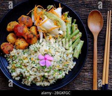 Top view plate of mixed fried rice with tofu pie, vegetables for nutrition vegetarian meal, Vietnamese vegan food so delicious ready to eat Stock Photo